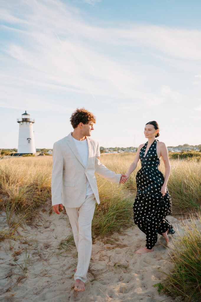 Bride and groom walking along the coastline of Martha's Vineyard