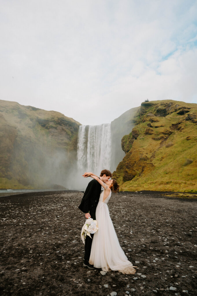 Skogafoss waterfall with bride and groom