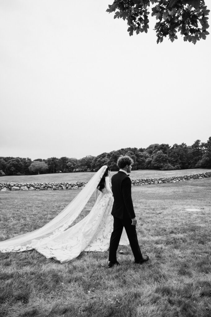Bride and groom walking side by side in the country side of Martha's Vineyard