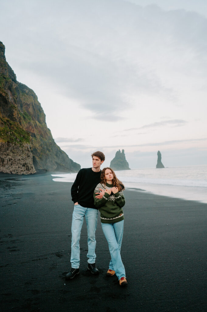 Couple walking on Iceland's Black Sand Beach